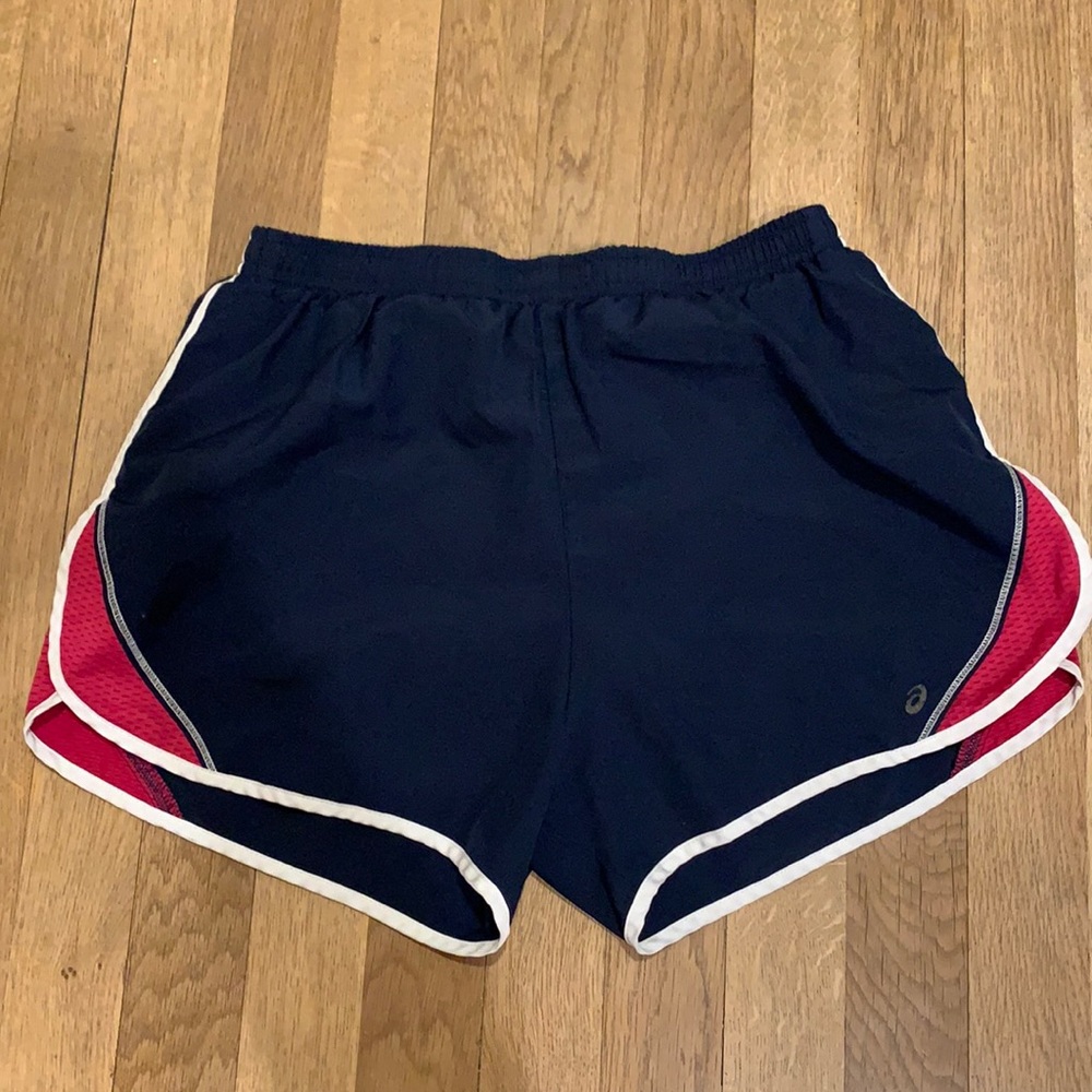 Asics navy running shorts w/pink detail. Women’s S